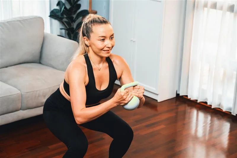 At-home strength training for women - JenCalling: Personal Training & Health Coaching Woman over 40 doing strength training at home