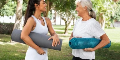 Senior fitness instructor leading group strength session in retirement community common area
